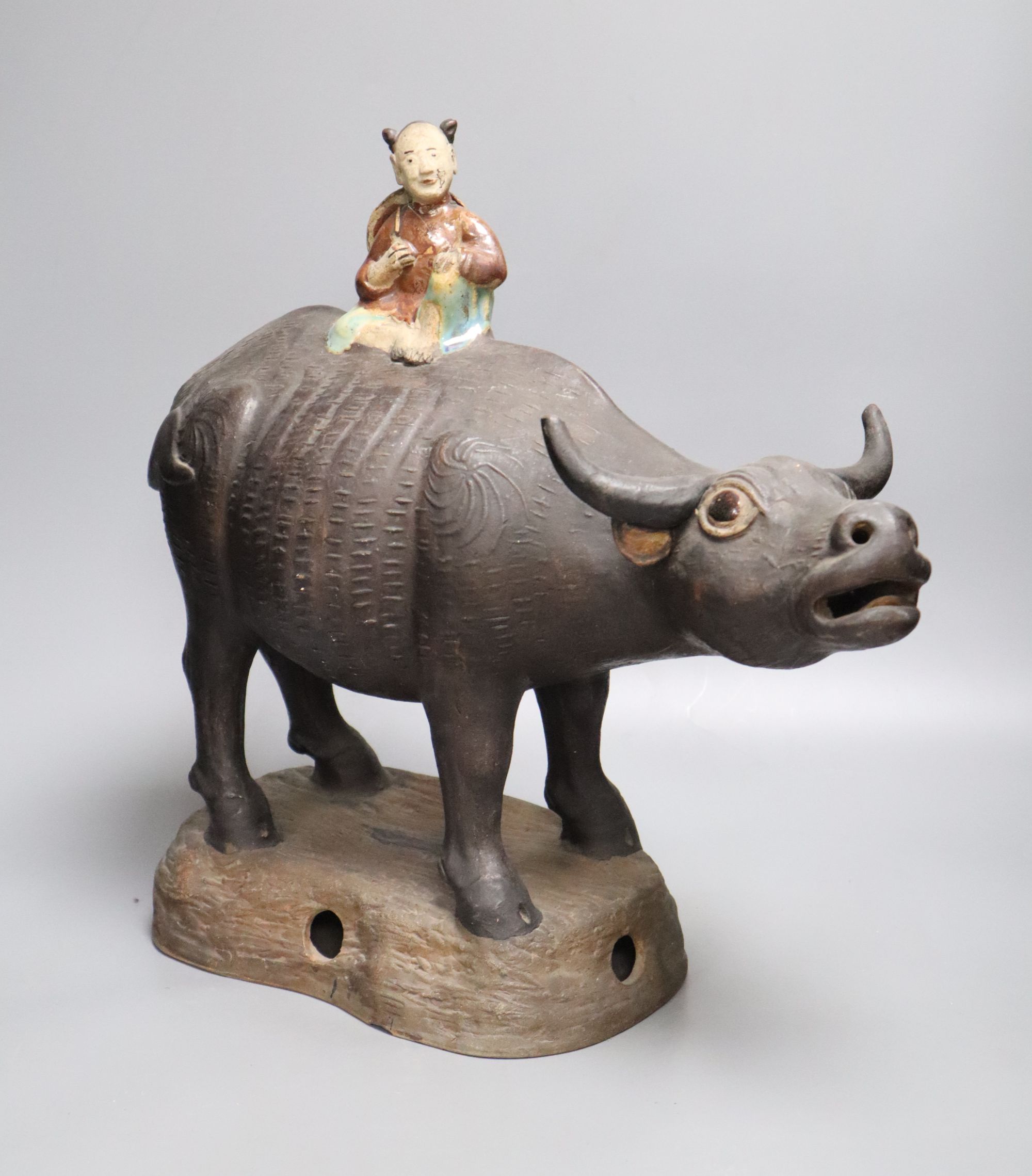 A large Chinese pottery group of a man riding an ox, Guandong kilns, height 40cm